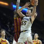 
              California guard Devin Askew (55) shoots the ball while defended by Southern California forward Joshua Morgan during the first half of an NCAA college basketball game in Berkeley, Calif., Wednesday, Nov. 30, 2022. (AP Photo/Godofredo A. Vásquez)
            