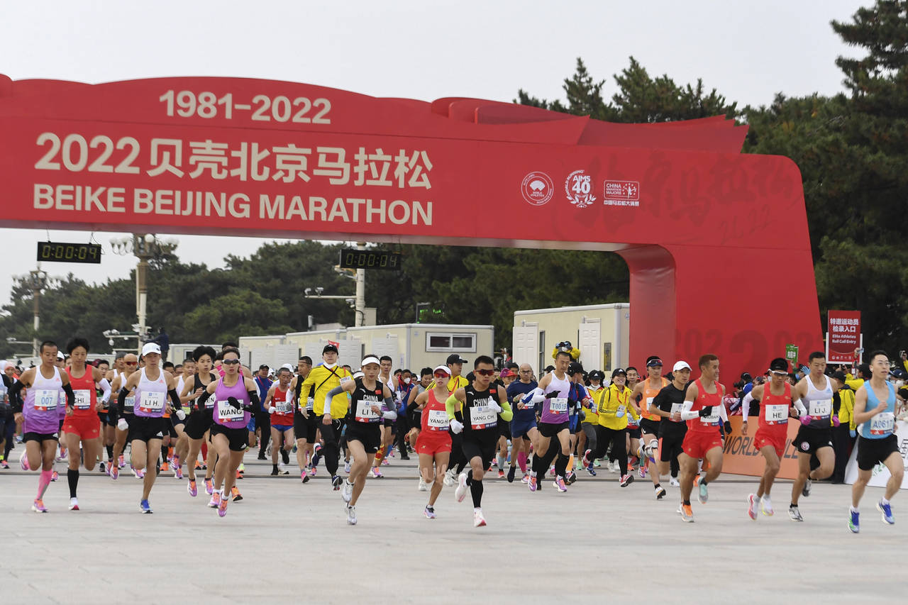 In this photo released by Xinhua News Agency, runners start to compete in the Beijing Marathon in B...