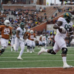 
              Baylor defensive lineman Gabe Hall (95) returns a fumble for a touchdown against Texas during the second half of an NCAA college football game in Austin, Texas, Friday, Nov. 25, 2022. (AP Photo/Eric Gay)
            