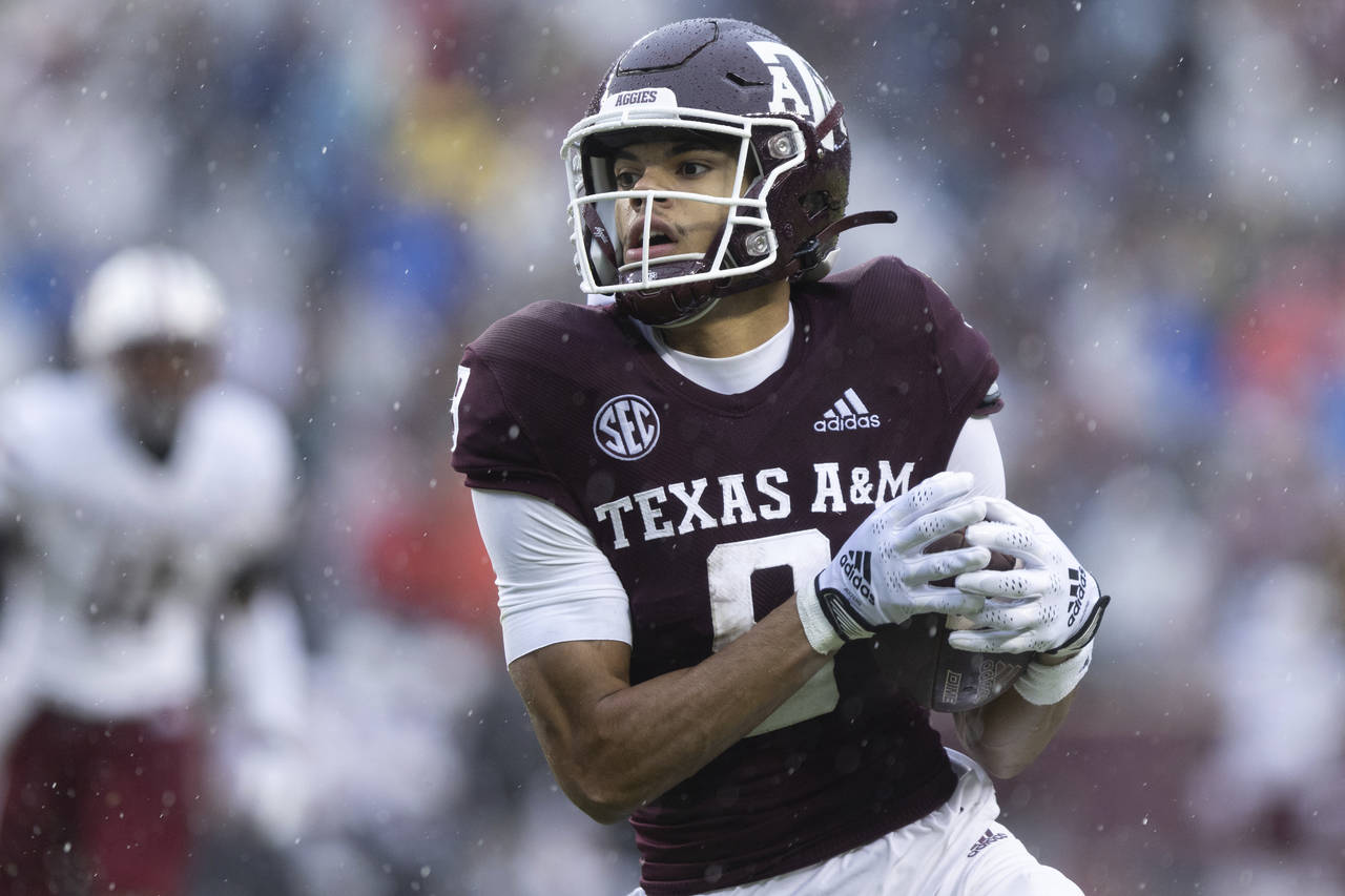 Texas A&M wide receiver Noah Thomas carries the ball in the first half of an NCAA college football ...