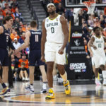 
              Baylor forward Flo Thamba (0) looks at the scoreboard as the team trails Virginia during the second half of an NCAA college basketball game Friday, Nov. 18, 2022, in Las Vegas. (AP Photo/Chase Stevens)
            