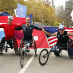 
              From left, men's wheelchair division third place finisher Jetze Plat, of the Netherlands, winner Marcel Hug, of Switzerland, and second place finisher Daniel Romanchuk pose at the finish line of the New York City Marathon, Sunday, Nov. 6, 2022, in New York. (AP Photo/Jason DeCrow)
            