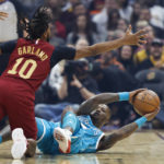 
              Charlotte Hornets guard Terry Rozier (3) looks to pass the ball against Cleveland Cavaliers guard Darius Garland (10) during the first half of an NBA basketball game Friday, Nov. 18, 2022, in Cleveland. (AP Photo/Ron Schwane)
            