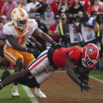 
              Georgia wide receiver Marcus Rosemy-Jacksaint (1) makes a catch for a touchdown as Tennessee defensive back Doneiko Slaughter (0) defends during the first half of an NCAA college football game Saturday, Nov. 5, 2022 in Athens, Ga. (AP Photo/John Bazemore)
            