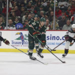 
              Minnesota Wild left wing Kirill Kaprizov (97) handles the puck against Arizona Coyotes center Nick Bjugstad (17) and defenseman J.J. Moser (90) during the first period of an NHL hockey game Sunday, Nov. 27, 2022, in St. Paul, Minn. (AP Photo/Stacy Bengs)
            