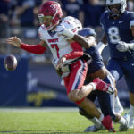 
              Liberty quarterback Kaidon Salter (7) fumbles the ball during the first half of an NCAA college football game against against the Connecticut in East Hartford, Conn., Saturday, Nov. 12, 2022. The play resulted in a Connecticut touchdown. (AP Photo /Bryan Woolston)
            