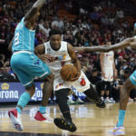 
              Charlotte Hornets guard Terry Rozier (3) and forward Jalen McDaniels (6) defend Miami Heat guard Kyle Lowry (7) during the first half of an NBA basketball game Saturday, Nov. 12, 2022, in Miami. (AP Photo/Marta Lavandier)
            