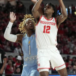 
              Houston guard Tramon Mark (12), right, draws a foul from Kent State forward VonCameron Davis (1) during the first half of an NCAA college basketball game Saturday, Nov. 26, 2022, in Houston. (AP Photo/Kevin M. Cox)
            