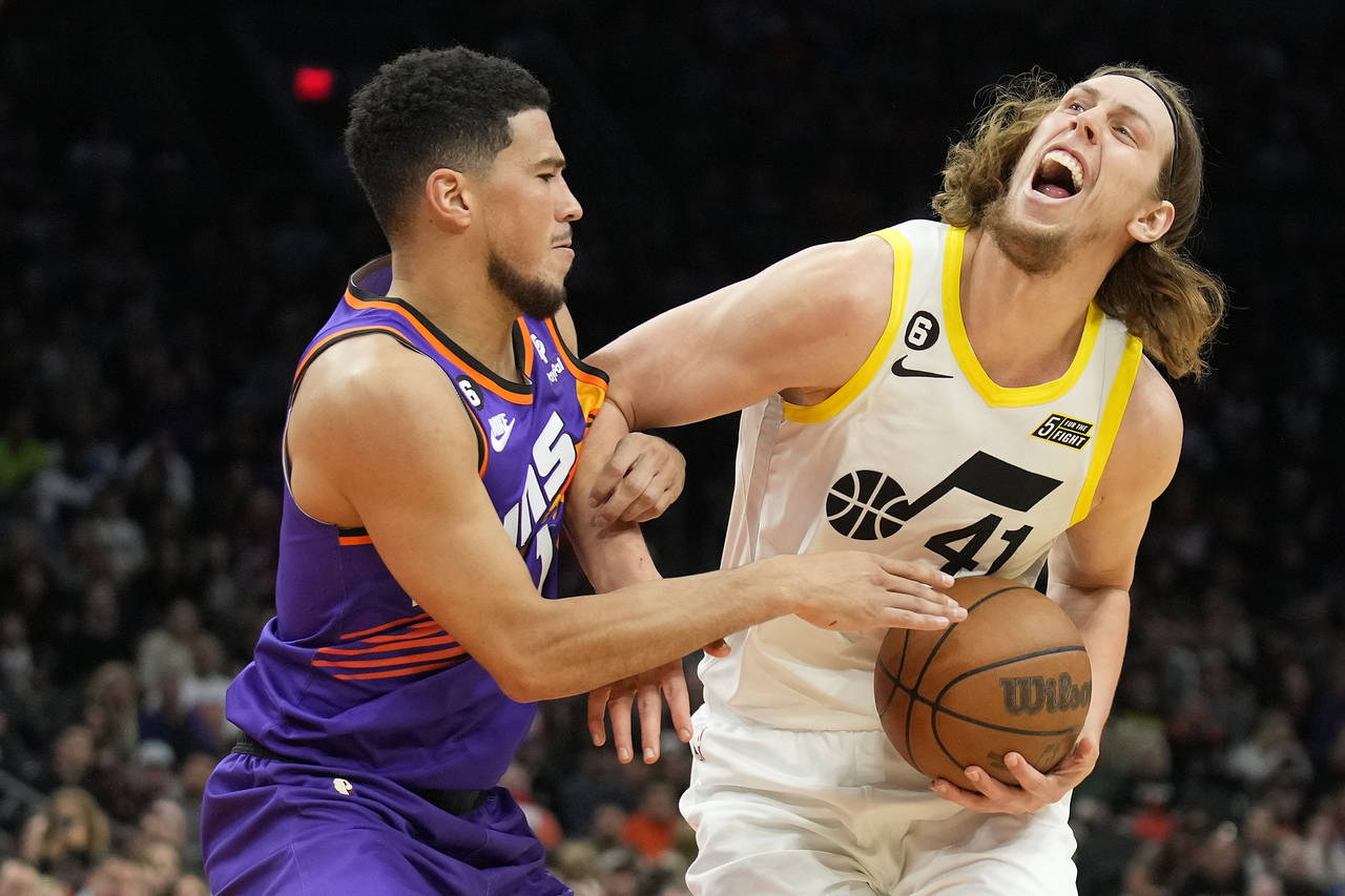Utah Jazz forward Kelly Olynyk (41) gets fouled by Phoenix Suns guard Devin Booker during the first...