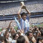 
              FILE - Diego Maradona, holds up the trophy, after Argentina beat West Germany 3-2 in the World Cup soccer final match, at the Atzeca Stadium, in Mexico City on June 29, 1986. (AP Photo/Carlo Fumagalli, File)
            