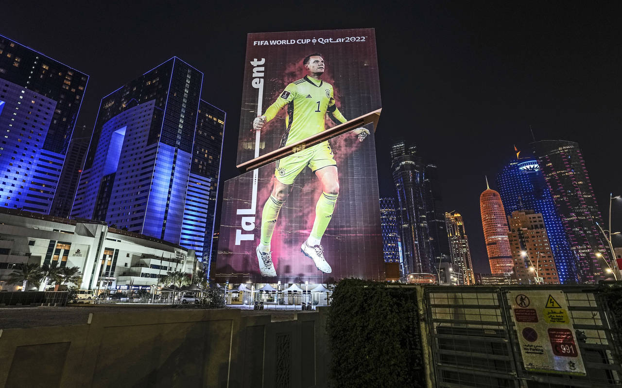 A giant FIFA World Cup advertisement on a skyscraper shows Germany's goalkeeper Manuel Neuer, readi...