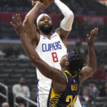
              Los Angeles Clippers forward Marcus Morris Sr., top, shoots as Indiana Pacers guard Buddy Hield defends during the first half of an NBA basketball game Sunday, Nov. 27, 2022, in Los Angeles. (AP Photo/Mark J. Terrill)
            