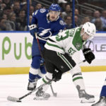 
              Dallas Stars center Wyatt Johnston (53) handles the puck next to Tampa Bay Lightning left wing Nicholas Paul (20) during the first period of an NHL hockey game Tuesday, Nov. 15, 2022, in Tampa, Fla. (AP Photo/Jason Behnken)
            