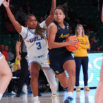 
              In a photo provided by Bahamas Visual Services, Marquette's Rose Nkumu, right, controls the ball against UCLA's Londynn Jones, left, during the NCAA college basketball championship game in the Battle 4 Atlantis at Paradise Island, Bahamas, Monday, Nov. 21, 2022. (Tim Aylen/Bahamas Visual Services via AP)
            