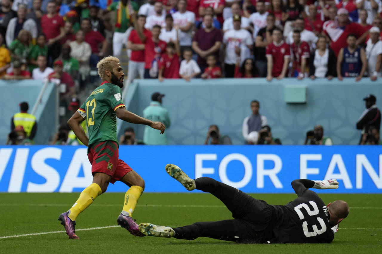 Cameroon's Eric Maxim Choupo-Moting, left, scores his side's third goal during the World Cup group ...