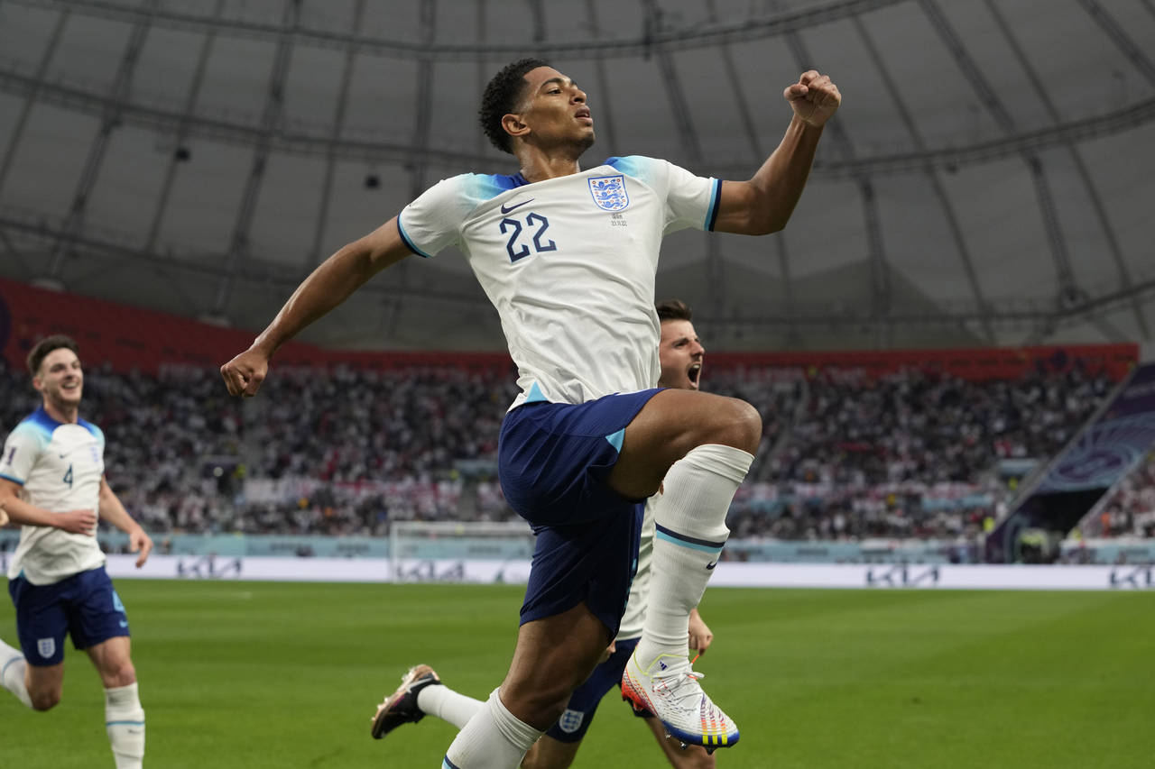 England's Jude Bellingham celebrates after scoring his side's opening goal during the World Cup gro...
