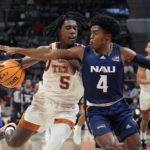 
              Texas guard Marcus Carr (5) drives against Northern Arizona guard Oakland Fort (4) during the first half of an NCAA college basketball game, Monday, Nov. 21, 2022, in Edinburg, Texas. (AP Photo/Eric Gay)
            