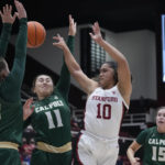 
              Stanford guard Talana Lepolo (10) passes the ball while defended by Cal Poly forward Julia Nielacna (32) and guard Junie Dickson (11) during the first half of an NCAA college basketball game in Stanford, Calif., Wednesday, Nov. 16, 2022. (AP Photo/Godofredo A. Vásquez)
            