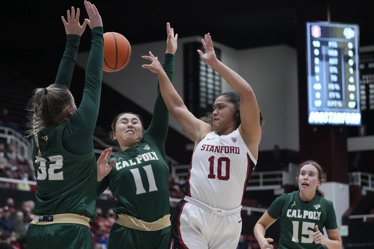 Stanford guard Talana Lepolo (10) passes the ball while defended by Cal Poly forward Julia Nielacna...