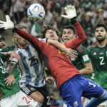 
              FILE - Mexico's goalkeeper Guillermo Ochoa goes for the ball during the World Cup group C soccer match between Argentina and Mexico, at the Lusail Stadium in Lusail, Qatar, Saturday, Nov. 26, 2022. (AP Photo/Hassan Ammar, File)
            