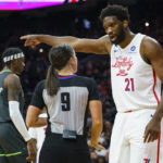 
              Philadelphia 76ers' Joel Embiid, right, reacts to a call by official Natalie Sago, center, during the first half of an NBA basketball game against the Minnesota Timberwolves, Saturday, Nov. 19, 2022, in Philadelphia. (AP Photo/Chris Szagola)
            