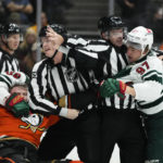 
              Anaheim Ducks' Max Jones, left, and Minnesota Wild's Kirill Kaprizov are separated by officials and Wild's Mats Zuccarello (36) during the second period of an NHL hockey game Wednesday, Nov. 9, 2022, in Anaheim, Calif. (AP Photo/Jae C. Hong)
            
