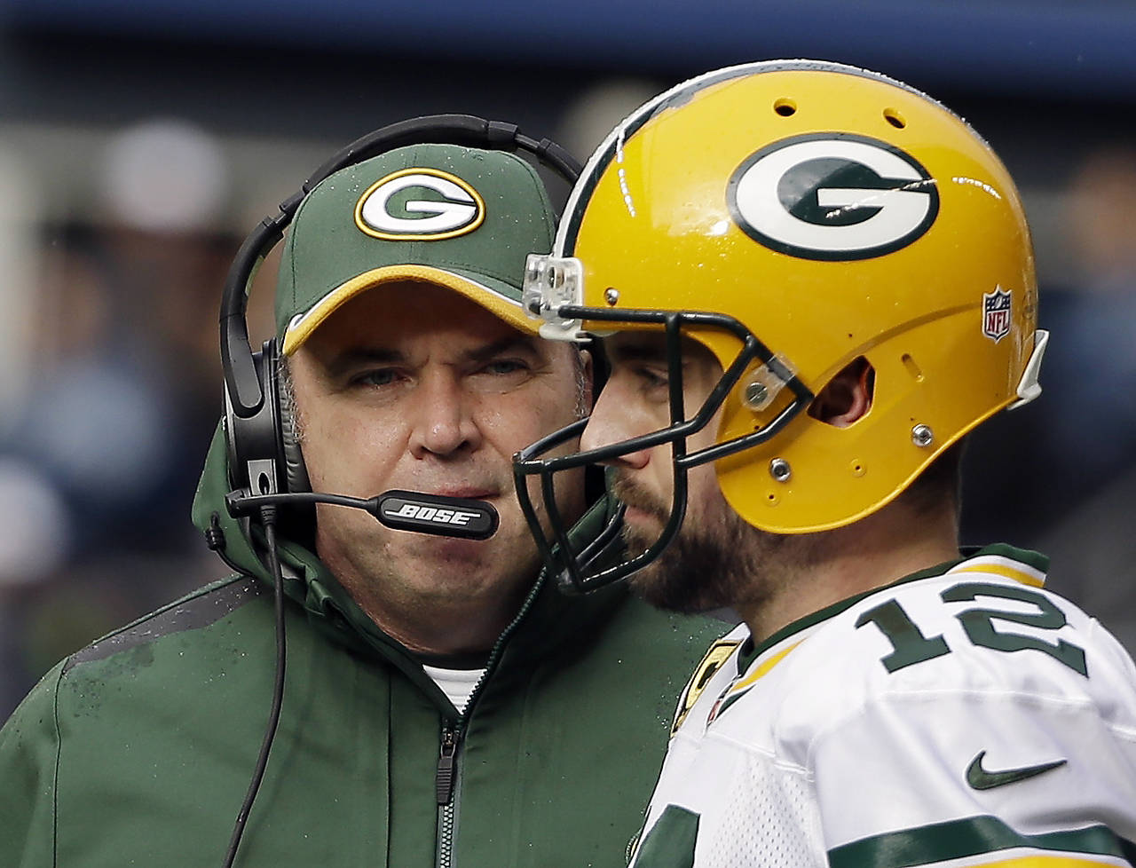 FILE - Green Bay Packers head coach Mike McCarthy talks to quarterback Aaron Rodgers (12) during th...