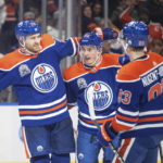 
              Edmonton Oilers' Leon Draisaitl (29), Tyson Barrie (22) and Ryan Nugent-Hopkins (93) celebrate a goal against the New Jersey Devils during the second period of an NHL hockey game Thursday, Nov. 3, 2022, in Edmonton, Alberta. (Jason Franson/The Canadian Press via AP)
            