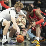 
              Wake Forest forward Zach Keller, left, and Georgia guard Kario Oquendo (3) scramble for the ball in the first half of an NCAA college basketball game Friday, Nov. 11, 2022, in Winston-Salem, N.C. (Allison Lee Isley/The Winston-Salem Journal via AP)
            