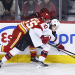 
              New Jersey Devils' Jesper Boqvist, right, vies for the puck against Calgary Flames' Noah Hanifin during the second period of an NHL hockey game Saturday, Nov. 5, 2022, in Calgary, Alberta. (Larry MacDougal/The Canadian Press via AP)
            