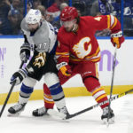 
              Calgary Flames defenseman Rasmus Andersson (4) pressures Tampa Bay Lightning left wing Alex Killorn (17) as he moves the puck along the dasher during the second period of an NHL hockey game Thursday, Nov. 17, 2022, in Tampa, Fla. (AP Photo/Chris O'Meara)
            