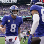 
              New York Giants quarterback Daniel Jones (8) celebrates with tight end Lawrence Cager (83) after Cager scored a touchdown against the Houston Texans during the first quarter of an NFL football game, Sunday, Nov. 13, 2022, in East Rutherford, N.J. (AP Photo/Seth Wenig)
            