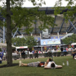 
              FILE - Tennis fans lounge on the grounds of the Billie Jean King National Tennis Center during the first round of the U.S. Open tennis championships, Tuesday, Aug. 31, 2021, in New York. The Westminster Kennel Club dog show is moving next year to a new venue: the home of the U.S. Open tennis tournament. The kennel club announced Thursday, Nov. 3, 2022, that canine champs will take over the USTA Billie Jean King National Tennis Center on May 6, 8 and 9.(AP Photo/John Minchillo, File)
            