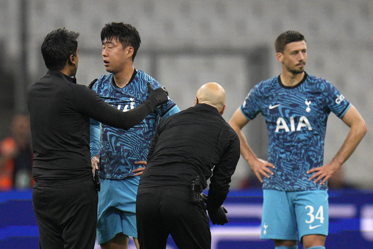 Tottenham's Son Heung-min receives treatment after taking a knock during the Champions League Group...