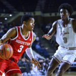 
              Houston guard Ramon Walker Jr. (3) drives to the basket against Saint Joseph's guard Cameron Brown (3) during the first half of an NCAA college basketball game at the Veterans Classic, Friday, Nov. 11, 2022, in Annapolis, Md. (AP Photo/Terrance Williams)
            