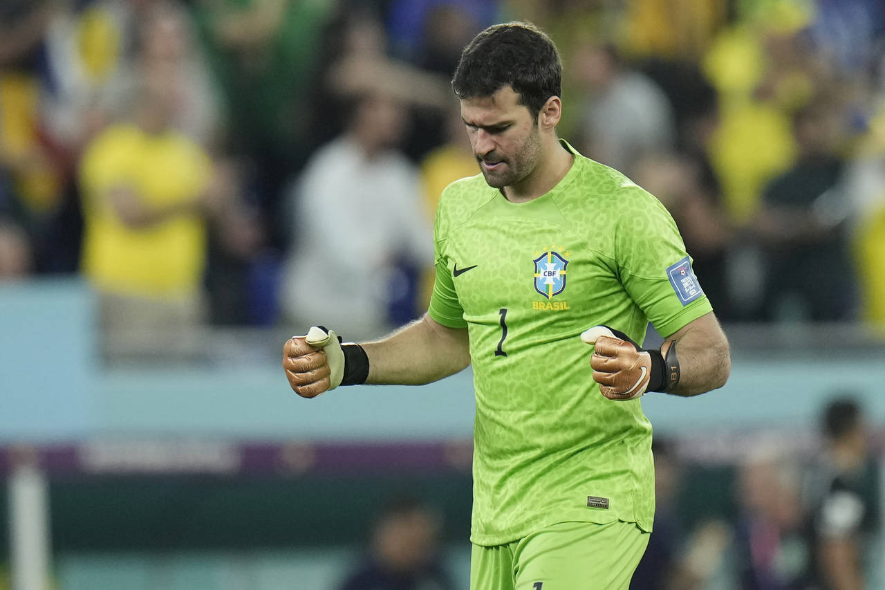 Brazil's goalkeeper Alisson celebrates after Casemiro scored the opening goal during the World Cup ...