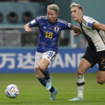 
              Japan's Takuma Asano, left, fights for the ball with Germany's Nico Schlotterbeck, on his way to score his side's second goal during the World Cup group E soccer match between Germany and Japan, at the Khalifa International Stadium in Doha, Qatar, Wednesday, Nov. 23, 2022. (AP Photo/Ebrahim Noroozi)
            