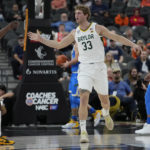 
              Baylor's Caleb Lohner (33) celebrates after a play against UCLA during the first half of an NCAA college basketball game Sunday, Nov. 20, 2022, in Las Vegas. (AP Photo/John Locher)
            