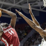 
              Alabama center Charles Bediako (14) works for a shot with South Alabama center Kevin Samuel (21) defending during the first half of an NCAA college basketball game Tuesday, Nov. 15, 2022, in Mobile, Ala. (AP Photo/Vasha Hunt)
            