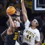
              Wichita State's Isaiah Poor Bear Chandler, right, defends against Missouri's Noah Carter during the first half of an NCAA college basketball game Tuesday, Nov. 29, 2022, in Wichita, Kan. (Travis Heying/The Wichita Eagle via AP)
            
