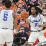
              UCLA guard Tyger Campbell (10) passes to guard Amari Bailey (5) during the first half of the team's NCAA college basketball game against Illinois on Friday, Nov. 18, 2022, in Las Vegas. (AP Photo/Chase Stevens)
            