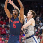 
              Dayton forward DaRon Holmes II (15) jumps to the basket for a layup as Robert Morris guard Jackson Last (12) fouls during the first half of an NCAA college basketball game, Saturday, Nov. 19, 2022, in Dayton, Ohio. (AP Photo/Joshua A. Bickel)
            