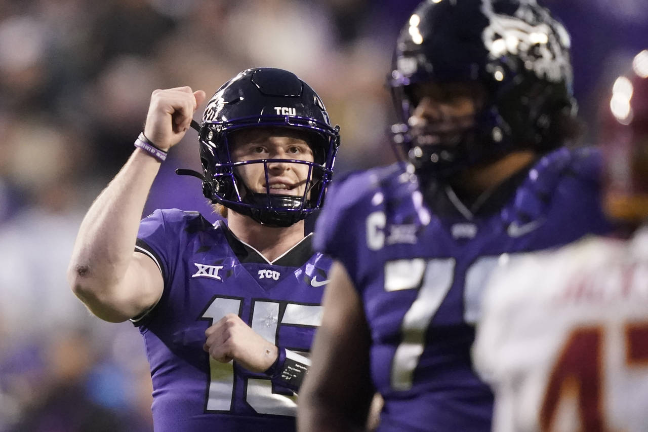 TCU quarterback Max Duggan reacts to throwing touchdown pass during the second half of an NCAA coll...