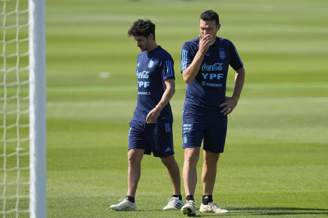 Argentina's head coach Lionel Scaloni, right, and assistant coach Pablo Aimar stand on the field du...