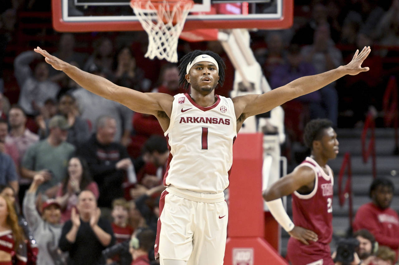 Arkansas guard Ricky Council IV (1) celebrates after scoring against Troy during the first half of ...