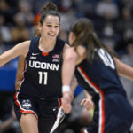 
              Connecticut's Lou Lopez-Senechal (11) celebrates with Connecticut's Nika Muhl during the second half of an NCAA college basketball game against North Carolina State, Sunday, Nov. 20, 2022, in Hartford, Conn. (AP Photo/Jessica Hill)
            
