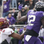 
              TCU tight end Geor'Quarius Spivey (12) pulls in a touchdown pass against Iowa State defensive back Anthony Johnson Jr. (1) during the first half of an NCAA college football game in Fort Worth, Texas, Saturday, Nov. 26, 2022. (AP Photo/LM Otero)
            