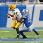 
              Green Bay Packers quarterback Aaron Rodgers (12) is sacked by Detroit Lions linebacker Derrick Barnes (55) during the first half of an NFL football game, Sunday, Nov. 6, 2022, in Detroit. (AP Photo/Paul Sancya)
            
