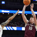 
              Bellarmine guard Garrett Tipton (10) shoots over Louisville forward JJ Traynor (12) during the first half of an NCAA college basketball game in Louisville, Ky., Wednesday, Nov. 9, 2022. (AP Photo/Timothy D. Easley)
            