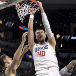 
              Los Angeles Clippers center Ivica Zubac (40) dunks over San Antonio Spurs forward Zach Collins, left, and guard Josh Richardson (7) during the second half of an NBA basketball game, Friday, Nov. 4, 2022, in San Antonio. (AP Photo/Nick Wagner)
            